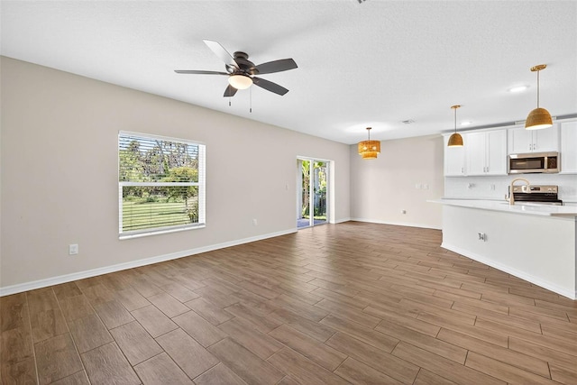 5413 Badini Way, Palmetto, FL 34221 - unfurnished living room with wood finished floors and ceiling fan