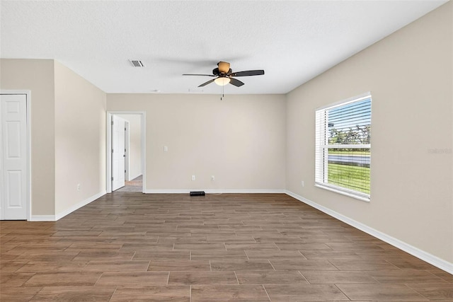 5413 Badini Way, Palmetto, FL 34221 - spare room featuring ceiling fan, wood finished floors, and a textured ceiling