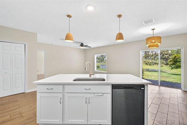 5413 Badini Way, Palmetto, FL 34221 - kitchen featuring dishwashing machine, light countertops, white cabinets, and hanging light fixtures