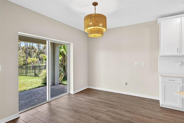 5413 Badini Way, Palmetto, FL 34221 - unfurnished dining area featuring wood finished floors and a chandelier