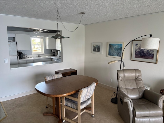 7401 Bay Island Dr S Unit 338, South Pasadena, FL 33707 - dining room with a textured ceiling and baseboards