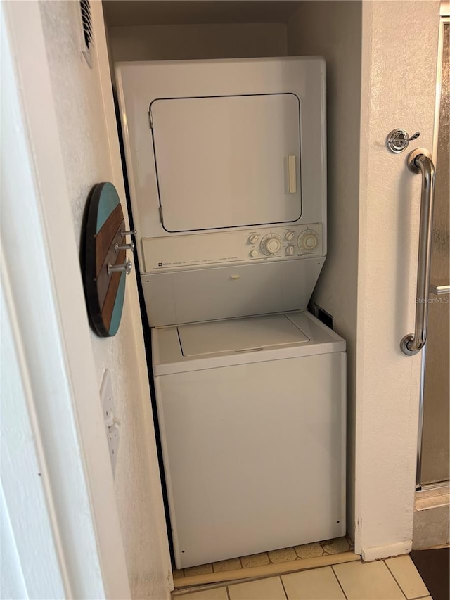 7401 Bay Island Dr S Unit 338, South Pasadena, FL 33707 - laundry room featuring estacked washer and dryer and light tile patterned flooring