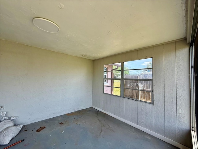 7400 Mako Dr, Hudson, FL 34667 - empty room with concrete flooring and wooden walls