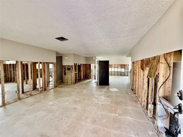 7400 Mako Dr, Hudson, FL 34667 - unfurnished living room with a textured ceiling and ceiling fan