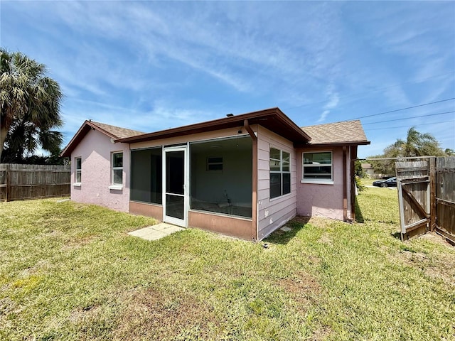 7400 Mako Dr, Hudson, FL 34667 - back of house featuring a sunroom, stucco siding, and a shingled roof