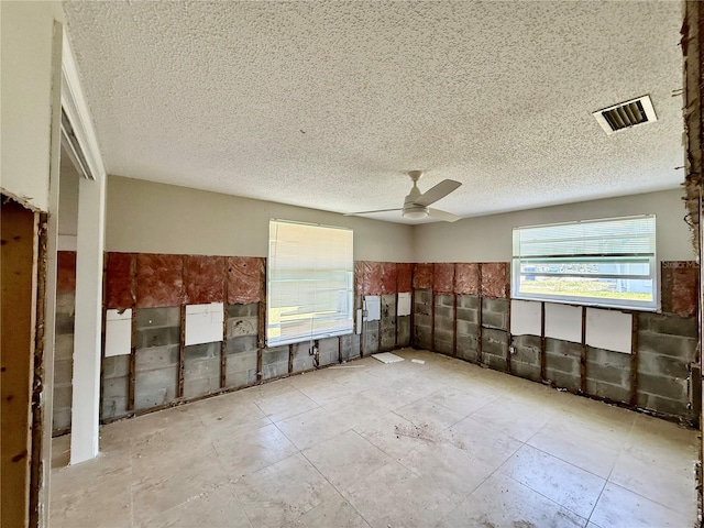 7400 Mako Dr, Hudson, FL 34667 - unfurnished room featuring a ceiling fan and a textured ceiling