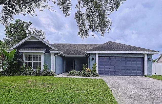 2049 Darlington Oak Dr, Seffner, FL 33584 - ranch-style home featuring a garage, concrete driveway, a front lawn, stucco siding, and roof with shingles