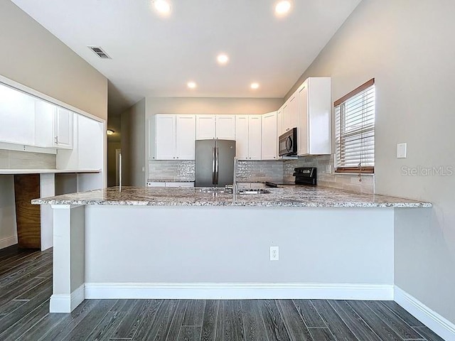 2049 Darlington Oak Dr, Seffner, FL 33584 - kitchen with black range with electric cooktop, stainless steel fridge, light stone countertops, dark wood-style flooring, and recessed lighting