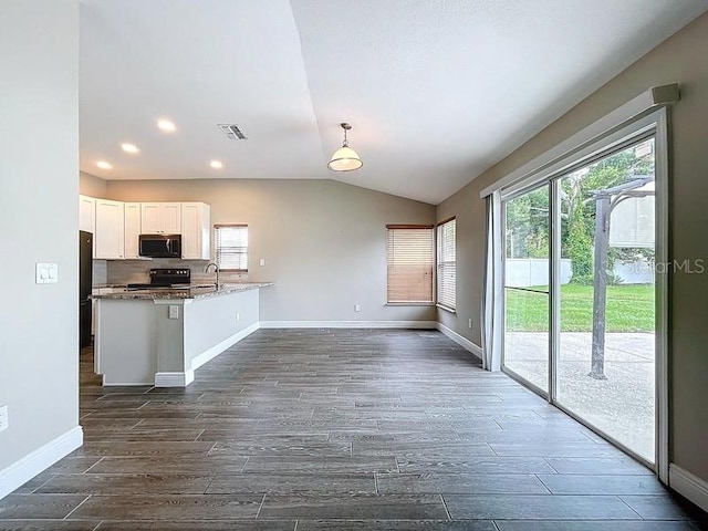 2049 Darlington Oak Dr, Seffner, FL 33584 - kitchen with stainless steel microwave, black / electric stove, dark wood-style flooring, white cabinetry, and lofted ceiling
