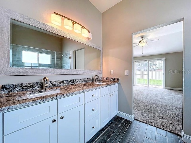 2049 Darlington Oak Dr, Seffner, FL 33584 - bathroom with double vanity, wood tiled floors, ceiling fan, lofted ceiling, and a tile shower