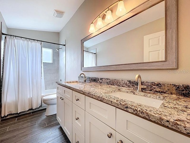 2049 Darlington Oak Dr, Seffner, FL 33584 - full bathroom with double vanity, wood finished floors, and shower / bath combo
