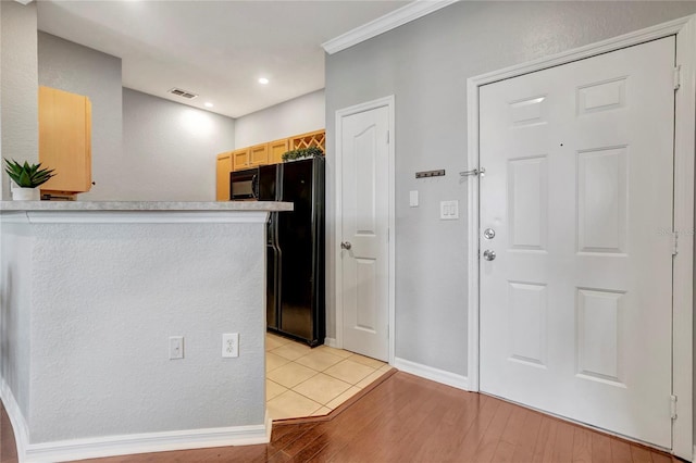 5000 Culbreath Key Way Unit 8-106, Tampa, FL 33611 - kitchen featuring freestanding refrigerator, light wood-style flooring, ornamental molding, light countertops, and recessed lighting
