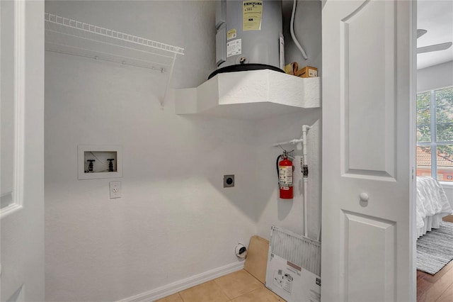 5000 Culbreath Key Way Unit 8-106, Tampa, FL 33611 - washroom with washer hookup, water heater, hookup for an electric dryer, and light tile patterned flooring