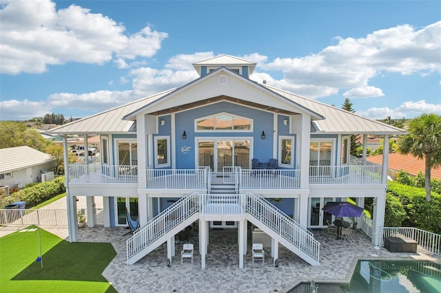 5521 Windward Way, New Port Richey, FL 34652 - rear view of property featuring a metal roof, a standing seam roof, and a patio