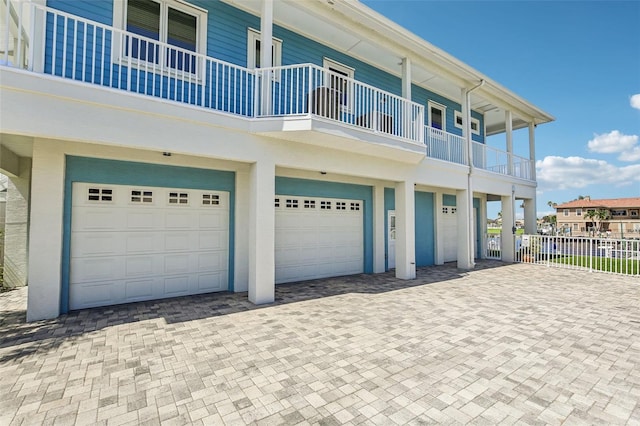 5521 Windward Way, New Port Richey, FL 34652 - view of front of property featuring a garage, decorative driveway, and a balcony