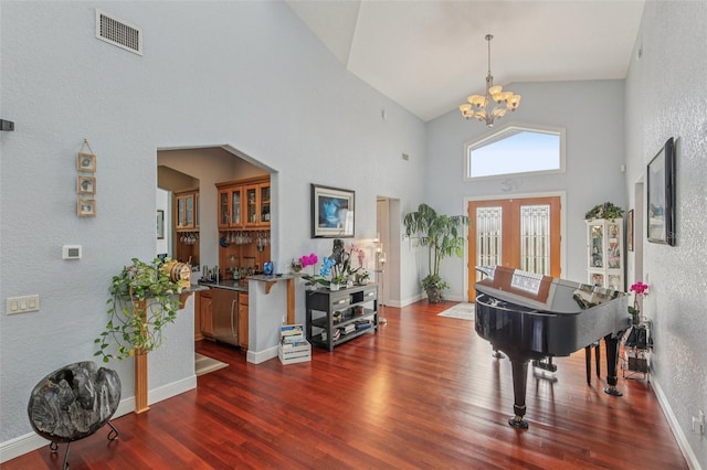 5521 Windward Way, New Port Richey, FL 34652 - foyer with high vaulted ceiling, a chandelier, dark wood-style floors, a textured wall, and french doors