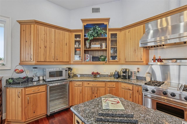 5521 Windward Way, New Port Richey, FL 34652 - kitchen with appliances with stainless steel finishes, wall chimney range hood, beverage cooler, and dark stone countertops
