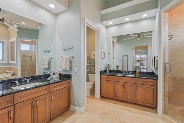 5521 Windward Way, New Port Richey, FL 34652 - bathroom featuring a ceiling fan, a stall shower, plenty of natural light, a textured wall, and vanity