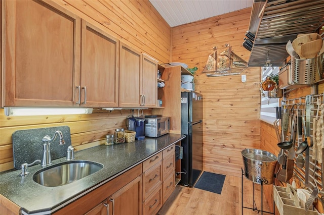5521 Windward Way, New Port Richey, FL 34652 - kitchen with wood walls, light wood-style floors, freestanding refrigerator, open shelves, and brown cabinets