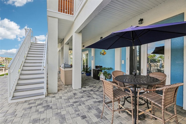 5521 Windward Way, New Port Richey, FL 34652 - view of patio / terrace with stairs and outdoor dining area