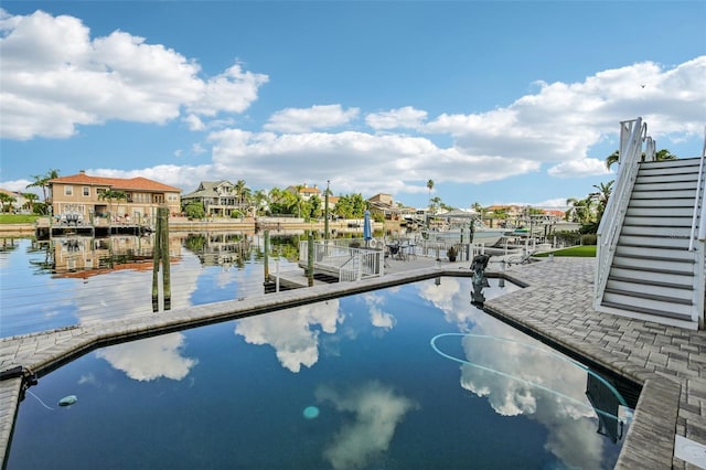 5521 Windward Way, New Port Richey, FL 34652 - view of swimming pool featuring a dock, a water view, and a residential view