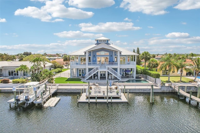 5521 Windward Way, New Port Richey, FL 34652 - back of property featuring stairs, a water view, a fenced backyard, and a patio area