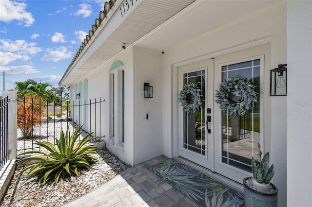 11599 Grove St, Seminole, FL 33772 - doorway to property featuring stucco siding and french doors