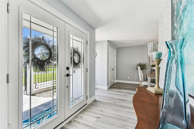 11599 Grove St, Seminole, FL 33772 - foyer entrance with plenty of natural light, light wood-style flooring, and a textured ceiling