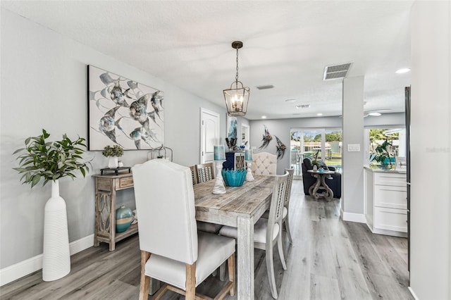 11599 Grove St, Seminole, FL 33772 - dining area with light wood finished floors and recessed lighting