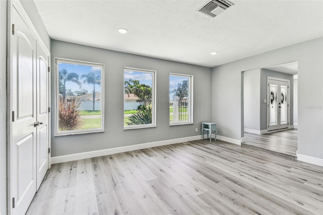 11599 Grove St, Seminole, FL 33772 - spare room with light wood-type flooring, recessed lighting, and a textured ceiling