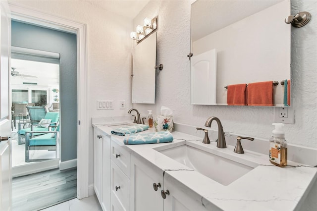 11599 Grove St, Seminole, FL 33772 - full bathroom featuring double vanity, a textured wall, and ceiling fan
