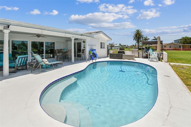11599 Grove St, Seminole, FL 33772 - outdoor pool with ceiling fan, a patio, and an outdoor kitchen