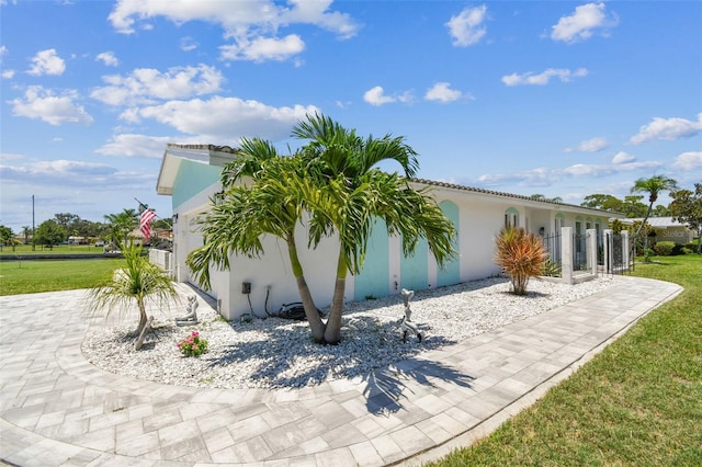 11599 Grove St, Seminole, FL 33772 - view of property exterior featuring stucco siding and a yard