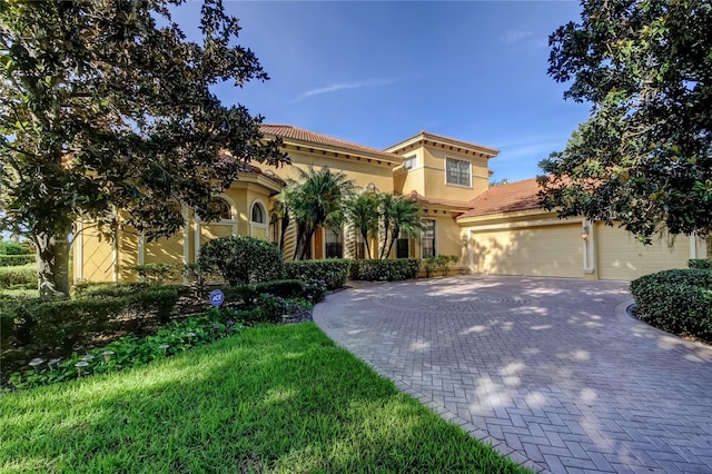 10504 Sabella Dr, Trinity, FL 34655 - mediterranean / spanish-style home with stucco siding, decorative driveway, a garage, and a tiled roof