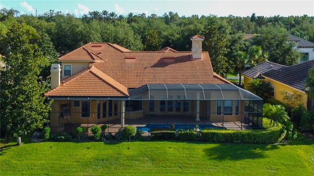 10504 Sabella Dr, Trinity, FL 34655 - rear view of house featuring a tiled roof, a chimney, a patio area, and a yard