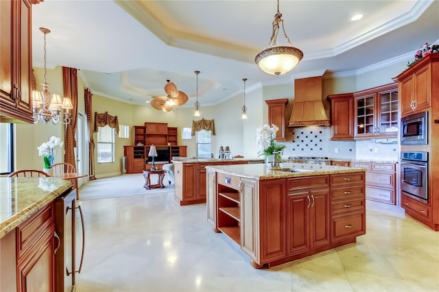 10504 Sabella Dr, Trinity, FL 34655 - kitchen with appliances with stainless steel finishes, a raised ceiling, custom exhaust hood, a chandelier, and pendant lighting