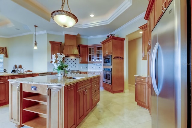 10504 Sabella Dr, Trinity, FL 34655 - kitchen featuring appliances with stainless steel finishes, ornamental molding, tasteful backsplash, custom exhaust hood, and a center island with sink