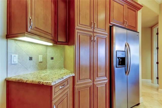 10504 Sabella Dr, Trinity, FL 34655 - kitchen with stainless steel refrigerator with ice dispenser, tasteful backsplash, light stone countertops, and dark brown cabinets