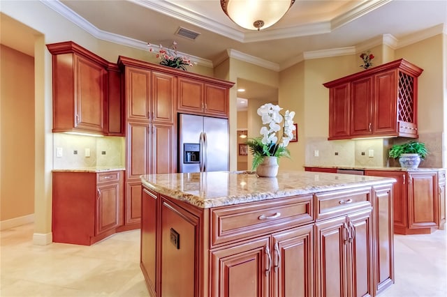 10504 Sabella Dr, Trinity, FL 34655 - kitchen featuring stainless steel refrigerator with ice dispenser, reddish brown cabinets, light stone counters, crown molding, and a kitchen island