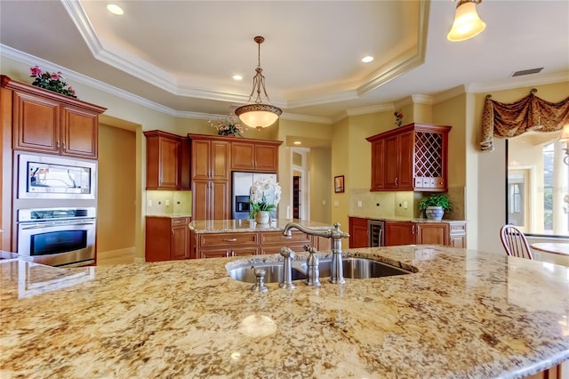 10504 Sabella Dr, Trinity, FL 34655 - kitchen with stainless steel appliances, a tray ceiling, light stone countertops, tasteful backsplash, and crown molding