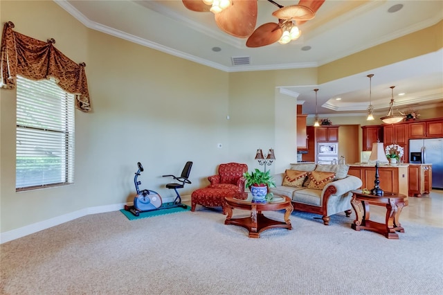 10504 Sabella Dr, Trinity, FL 34655 - living room featuring a tray ceiling, crown molding, light carpet, and ceiling fan