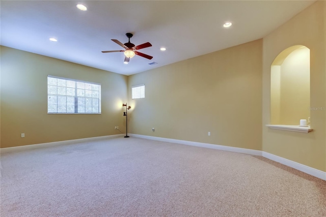 10504 Sabella Dr, Trinity, FL 34655 - empty room featuring light carpet, a ceiling fan, recessed lighting, and arched walkways
