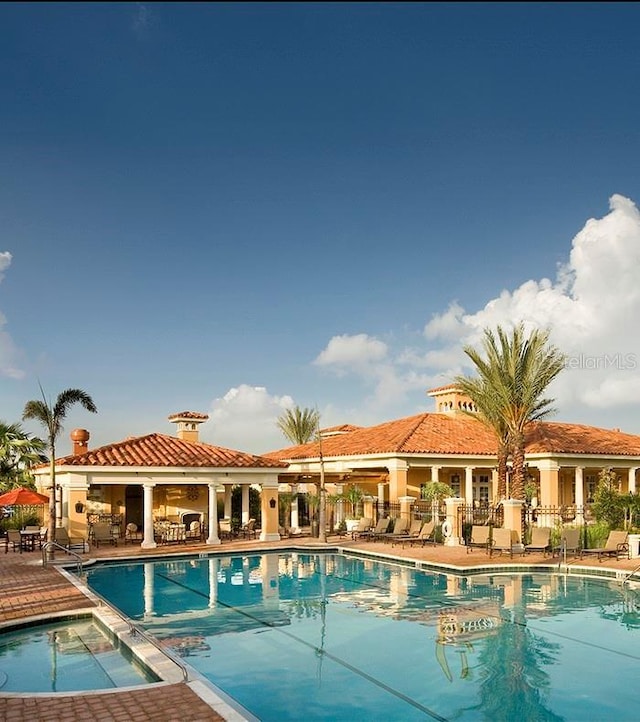 10504 Sabella Dr, Trinity, FL 34655 - community pool with a patio area