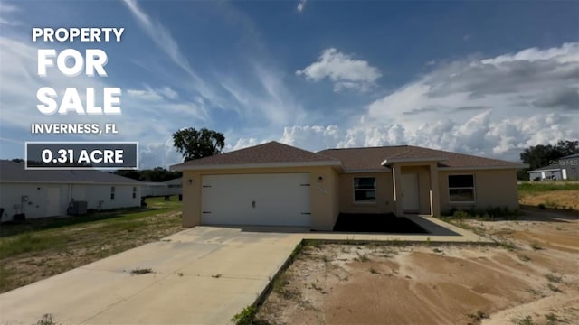 4251 E Walker St, Inverness, FL 34453 - view of front of house with an attached garage, driveway, and stucco siding