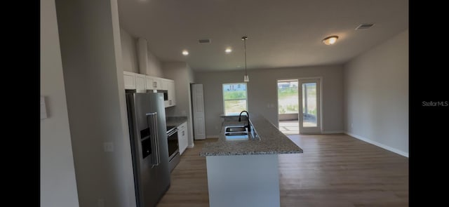 4251 E Walker St, Inverness, FL 34453 - kitchen featuring stainless steel appliances, white cabinetry, light wood-type flooring, a center island with sink, and recessed lighting