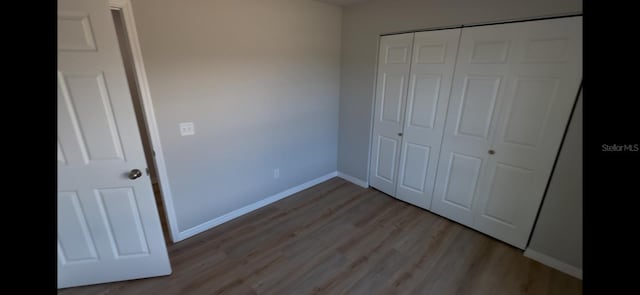 4251 E Walker St, Inverness, FL 34453 - unfurnished bedroom with light wood-type flooring and a closet