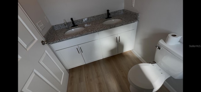 4251 E Walker St, Inverness, FL 34453 - half bathroom featuring double vanity and wood finished floors