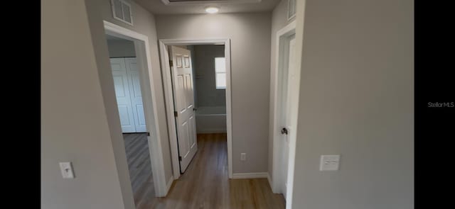 4251 E Walker St, Inverness, FL 34453 - hallway with light wood-style floors and baseboards