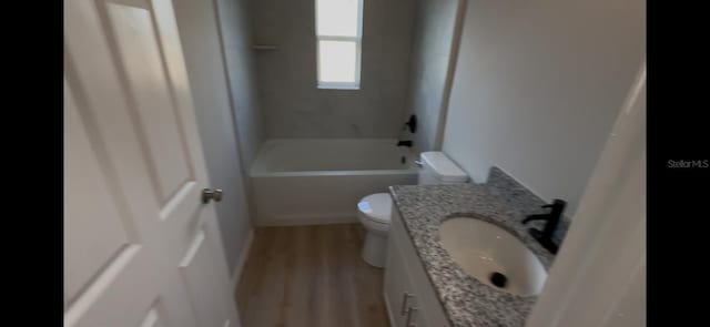 4251 E Walker St, Inverness, FL 34453 - full bath with wood finished floors, vanity, and tub / shower combination