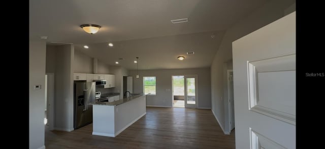 4251 E Walker St, Inverness, FL 34453 - kitchen featuring appliances with stainless steel finishes, wood finished floors, white cabinetry, a kitchen island with sink, and high vaulted ceiling